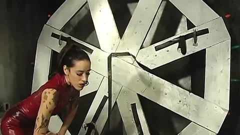 Sexy dominatrix in red leather makes a guy do her wishes